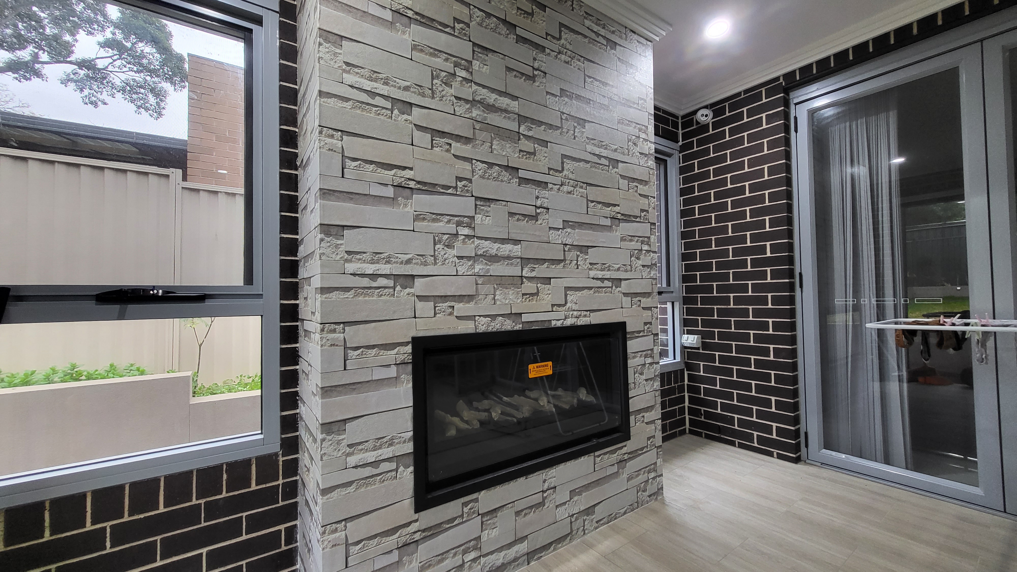 Fireplace feature wall wallpaper by Wallpaper Masters