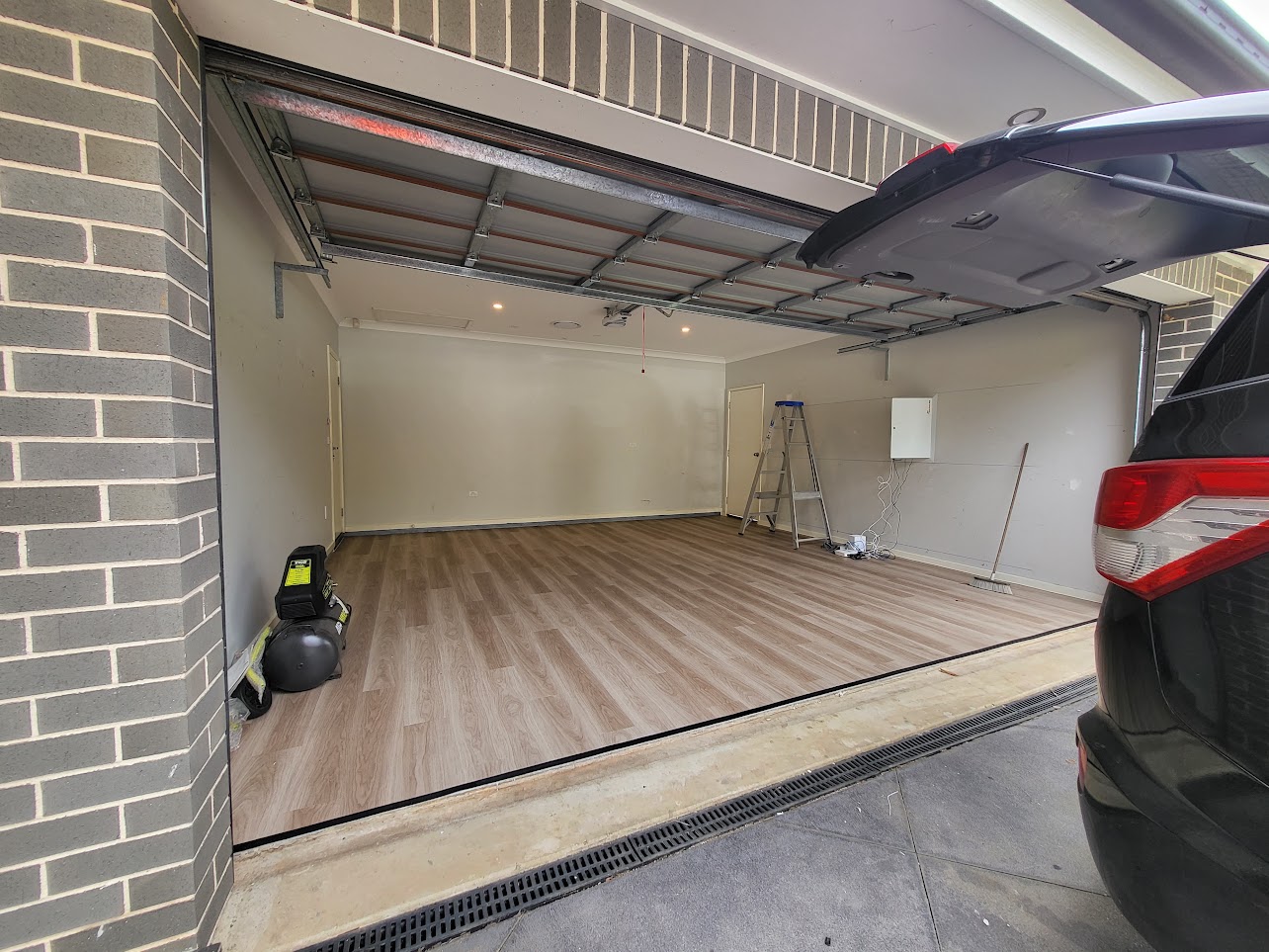 Warm natural oak flooring installed in a residential garage
